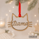 imagen principal con fondo navideño de bola navideña en tablex para mascotas con silueta con forma de cara de gato personalizada con el nombre por dentro de la silueta y cinta roja para colgar del árbol de navidad.